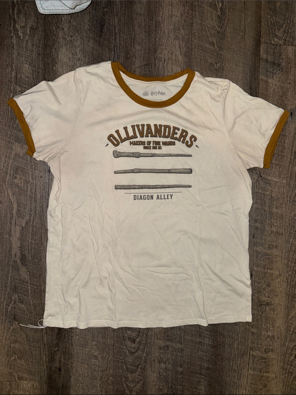 Warner Bros. Ollivanders Cream Tee with Gold Trim
